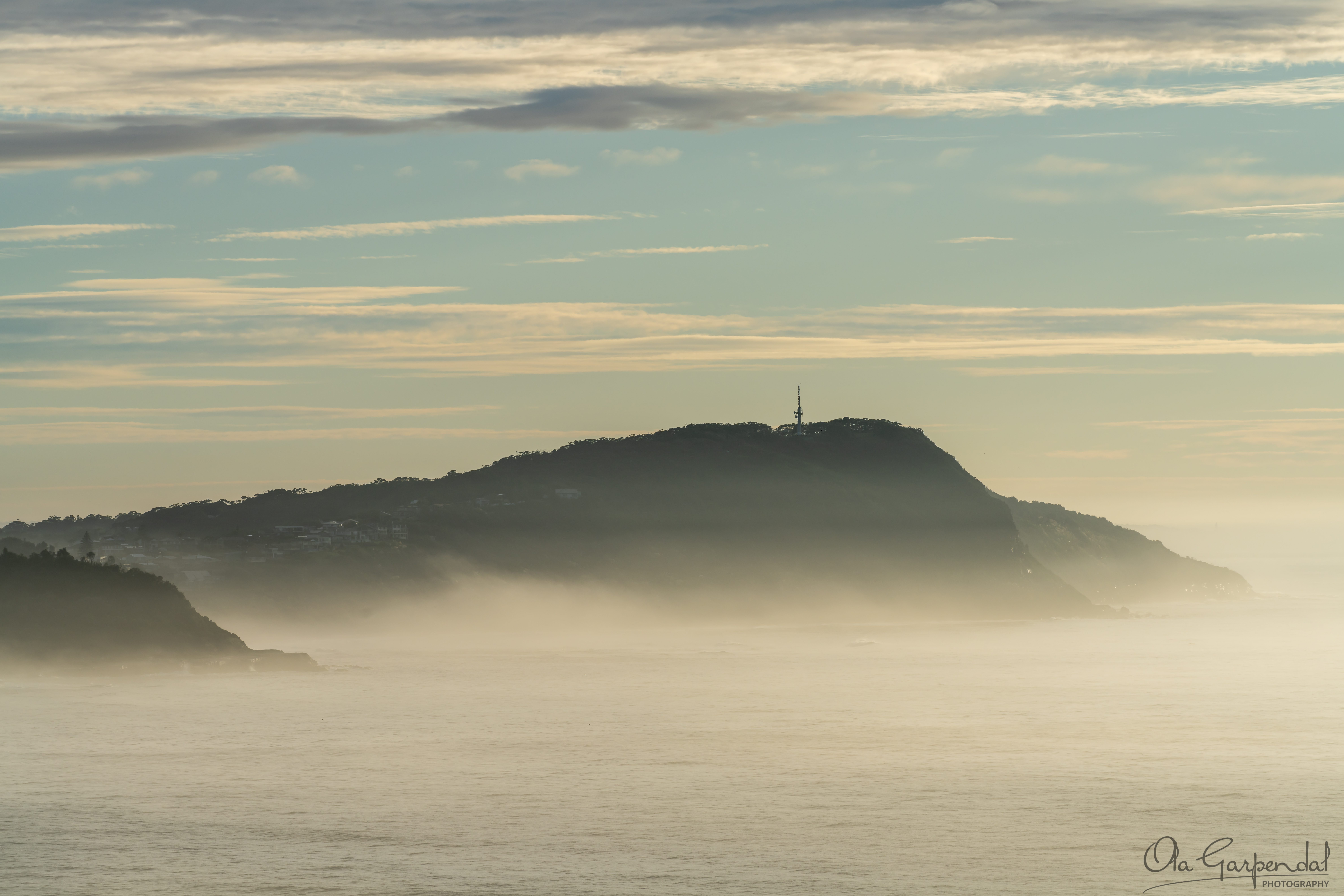 Forresters Beach, headland rising from the sea fog, photographed by Ola Garpendal Photography