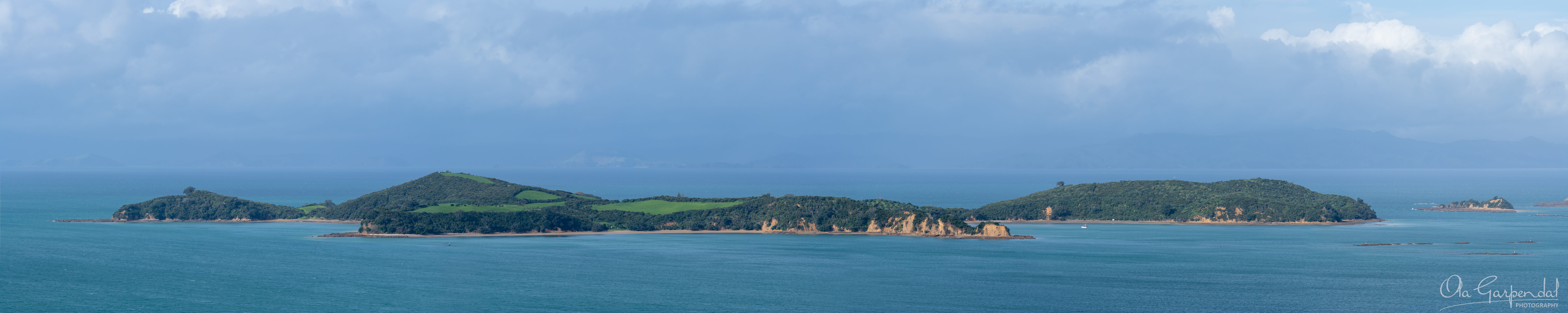 Rotoroa Island, panoramic fine art print of forested ridgelines and sandstone cliffs in the Hauraki Gulf NZ, photographed by Ola Garpendal Photography.